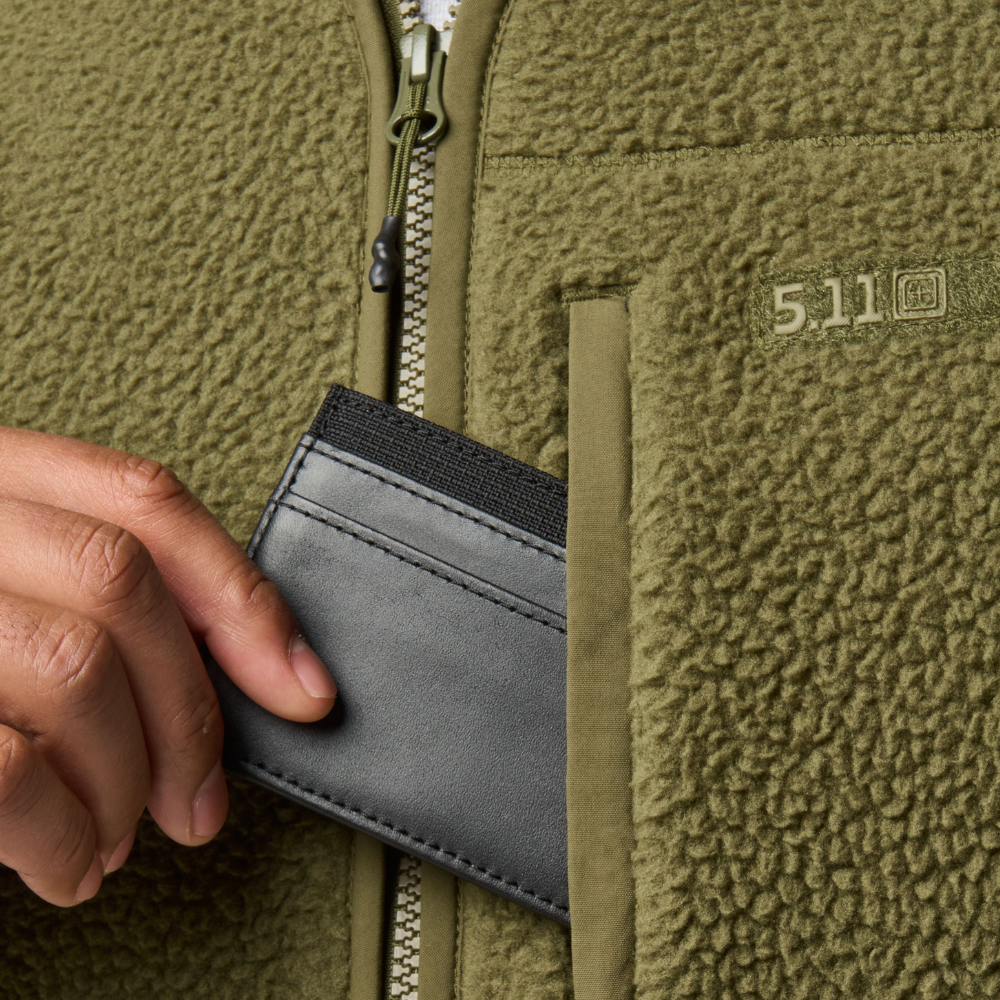 Close-up of a wallet in the pocket of the 5.11 Tactical HQ Tech Fleece Jacket in Field Green