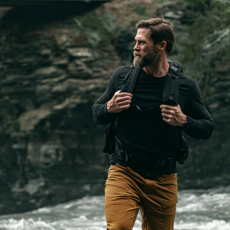 Man standing outdoors wearing the 5.11 Tactical PT-R Charge Long Sleeve 2.0 in Black Heather