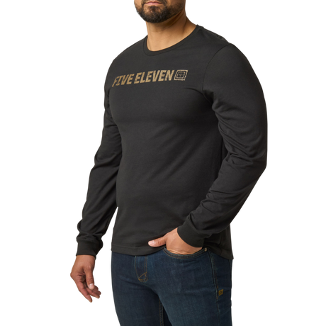 Man wearing the 5.11 Tactical Weathered Lock Up Long Sleeve Tee in Black with a distressed tan Five Eleven chest print, angled to the left