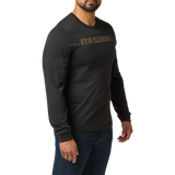 Man wearing the 5.11 Tactical Weathered Lock Up Long Sleeve Tee in Black with a distressed tan Five Eleven chest print, angled to the right