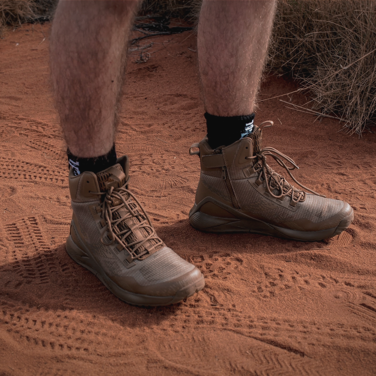 Person wearing Reebok Nano X1 Adventure 6 tactical side zip boot in coyote outdoors