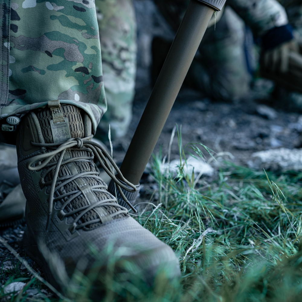 Person wearing Reebok Nano X1 Adventure 6 tactical side zip boot in coyote